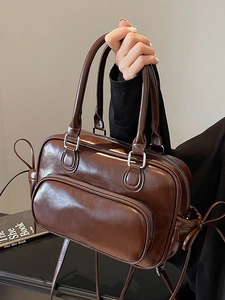 Vintage dark brown faux leather bowling bag with stylish bow details and front pocket