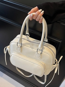 Versatile white minimalist bowling bag with textured leather and silver hardware details