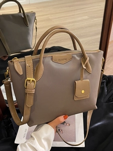 Minimalist khaki crossbody tote bag with top zipper and gold hardware details