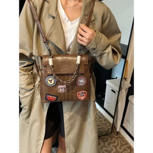 Vintage brown leather backpack with street style patches and adjustable shoulder straps