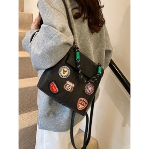 Vintage college-style black leather backpack with colorful embroidery and woven handle