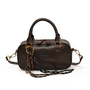 Deep brown vintage Boston handbag with metallic tennis racket charm and textured finish