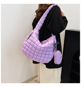 Lavender purple quilted cloud bag with matching mini round pouch on shoulder strap