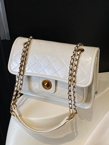 Elegant white quilted crossbody bag with gold chain strap and vintage twist lock