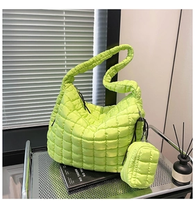 Detail view of neon green quilted puffer bag with matching small coin purse and zipper