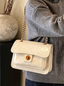 Elegant white quilted chain handbag with gold twist lock and diamond pattern design