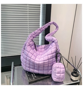Detail of purple quilted puffer bag with matching small square coin purse attachment