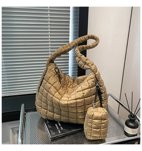 Detailed view of champagne gold quilted puffer bag with matching mini square coin pouch