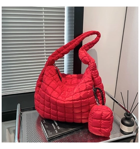 Detail of red quilted hobo bag with matching mini pouch and puffy nylon texture