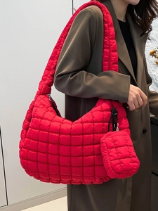 Quilted puffy hobo bag in bright red with matching mini pouch on a female model