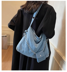 Blue washed denim hobo bag featuring a stylish silver chain and matching mini pouch