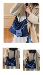 Detail of blue denim tote bag with silver chain and detachable mini coin pouch