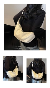 Detail view of cream pleated hobo bag showing texture and wide shoulder strap