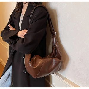 Detailed view of the dark brown hobo bag with unique pleated texture on synthetic leather