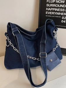 Deep blue denim tote bag with silver chain, adjustable strap and small coin purse
