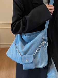 Denim tote bag for women featuring a chunky silver chain and a detachable coin pouch