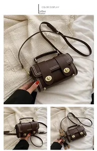Detail of retro brown leather handbag with gold studs and dual twist-lock closure