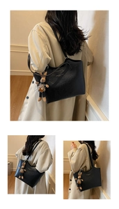 Détail du sac cabas noir en cuir PU avec texte blanc et charm lapin en peluche marron