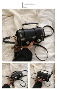 Detail view of a black crossbody bag with golden studs and a small teddy bear charm