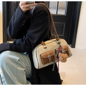 Model wearing a vintage two-tone Boston bag with cream and brown leather detailing