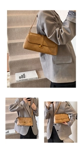 Detail of brown leather shoulder bag with vintage gold G buckle and slim strap