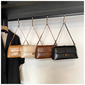 Detail view of stylish underarm bags in four colors with a metallic gold G buckle