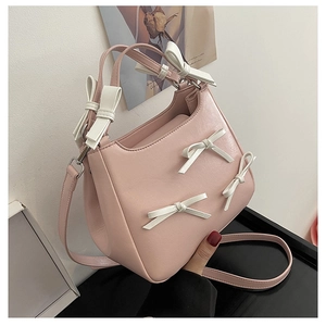 Detailed view of pink sweet style crossbody bag with white decorative 3D bows
