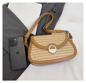 Detail shot of mini contrast woven shoulder bag showing real capacity with smartphone and book