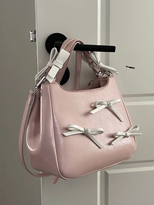 Pink PU leather crossbody bag featuring 3D white bows on the front and handle