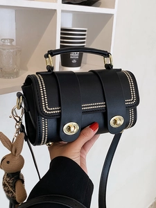 Retro black leather handbag with gold rivets, crossbody strap and a cute rabbit charm