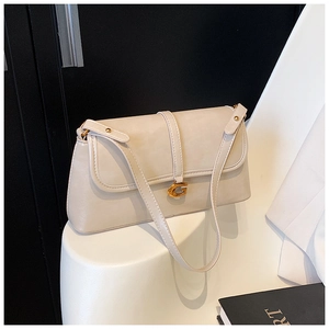 Close-up of cream white shoulder bag featuring gold G-buckle and contrast stitching