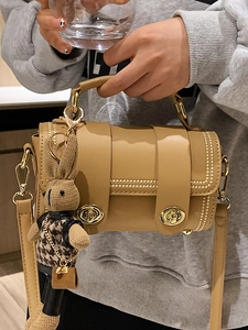 Retro contrast color cylindrical handbag in khaki leather with a cute rabbit charm