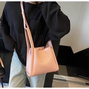 Detail showing the pink lychee-patterned leather texture and FAMEROO brand embossing