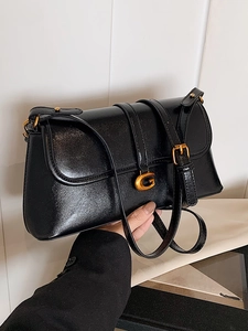 Chic black polished underarm bag with gold G buckle and adjustable leather strap