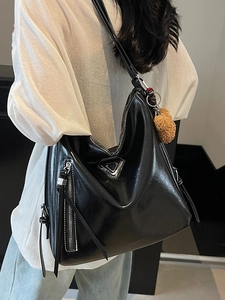 Fashionable black glossy tote bag with large capacity and decorative triangle hardware