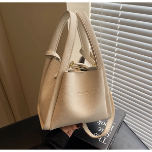 Detail view of cream lychee texture bucket bag with HAMIROO logo and dual handles