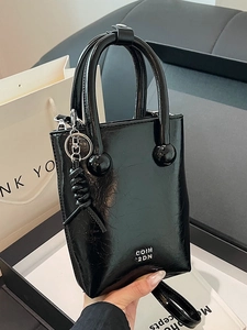 Chic black oil-wax textured handbag with silver COIN 2DN logo and unique round handle