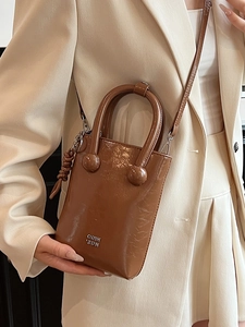 Brown oil-wax leather mini tote bag with silver logo and crossbody strap for women