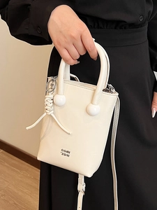 Minimalist beige oil-wax leather tote bag with double round handles and shoulder strap