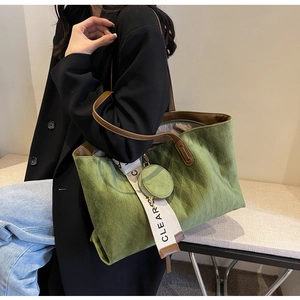 Detail of olive green quilted tote bag with brown leather handles and mini round purse