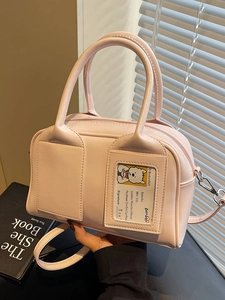 Elegant light pink boston bag in synthetic leather with cute cartoon dog card insert detail