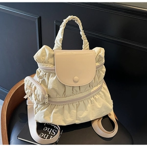 Detail of cream pleated nylon backpack with smooth PU flap and matching hanging pouch