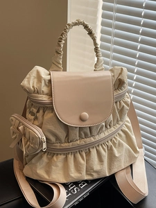 Beige pleated nylon backpack for women with smooth leather flap and cute bow charm