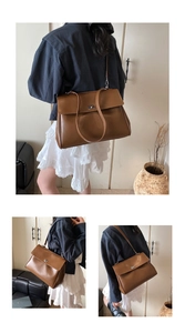 Detail view of brown vintage leather satchel with silver metal turn-lock and adjustable strap