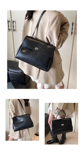Close-up of minimalist black leather briefcase with metal twist lock for business commute