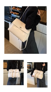 Close-up of beige minimalist commuter briefcase featuring a metal turn-lock closure