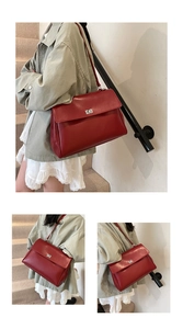 Detail of red matte leather briefcase showing silver metal swivel lock and large capacity
