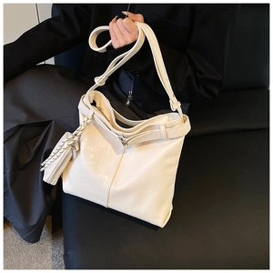 Detail view of cream white PU leather tote bag with a matching mini coin purse attachment