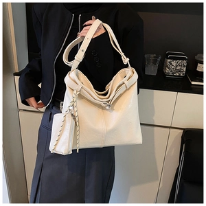 Detail of off-white PU leather tote bag with adjustable strap and small side pouch