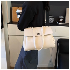Chic cream white large capacity tote bag styled in a modern office business setting